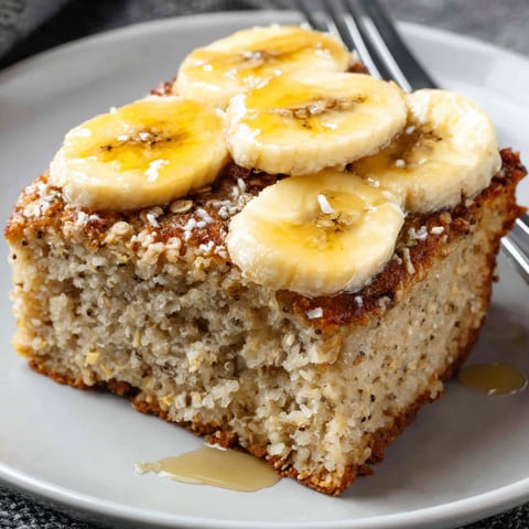 A slice of banana bread with bananas on top.