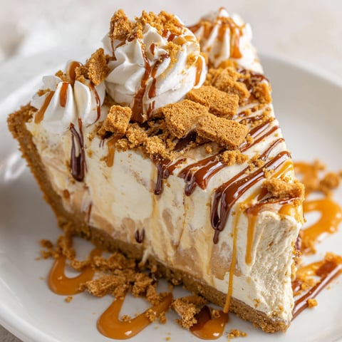 A slice of a pie with a caramel sauce drizzled on top.